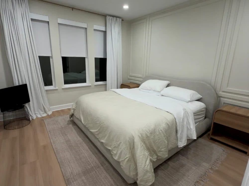 Interior repaint — a bedroom in a warm neutral with a white ceiling and trim.